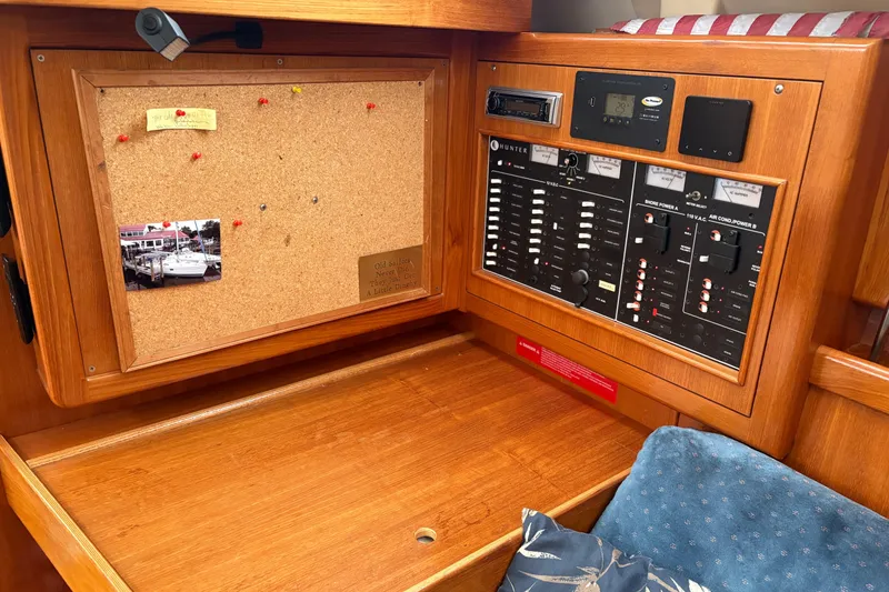 Slide: The Image of Control panel and corkboard in a 2002 Hunter 386 sailboat interior. - 16