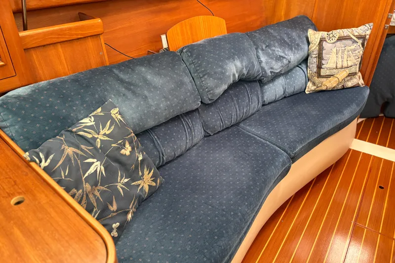 Slide: The Image of Luxurious interior of 2002 Hunter 386 yacht with plush blue seating and decorative pillows. - 21