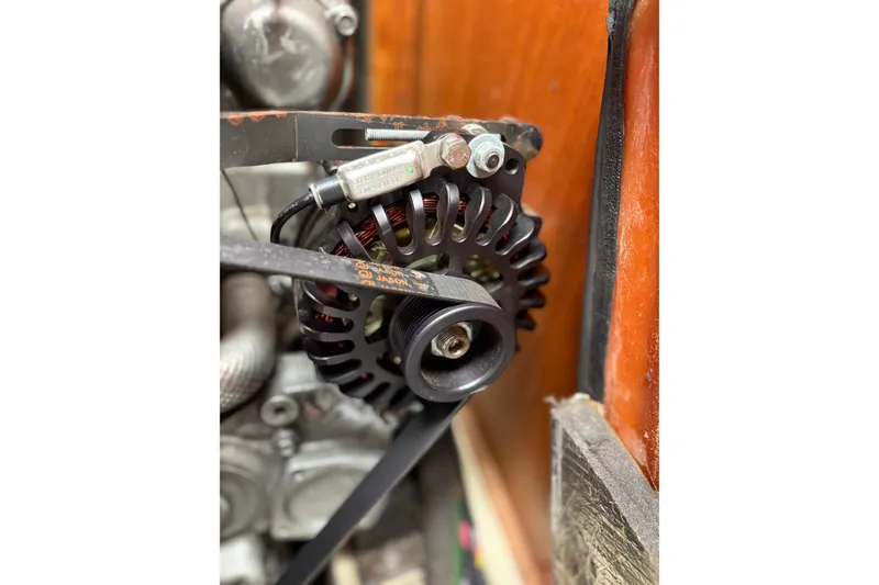 Slide: The Image of Close-up of a 2002 Hunter 386 engine component with belt and pulley system. - 25