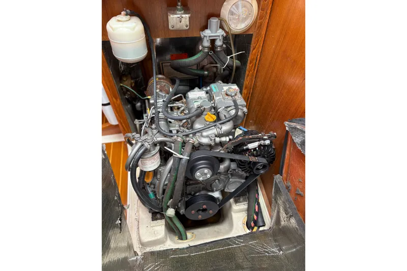 Slide: The Image of Engine compartment of a 2002 Hunter 386 sailboat, showcasing detailed mechanical components. - 26