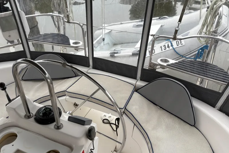Slide: The Image of Interior view of a 2002 Hunter 386 sailboat cockpit with steering wheel and compass. - 4