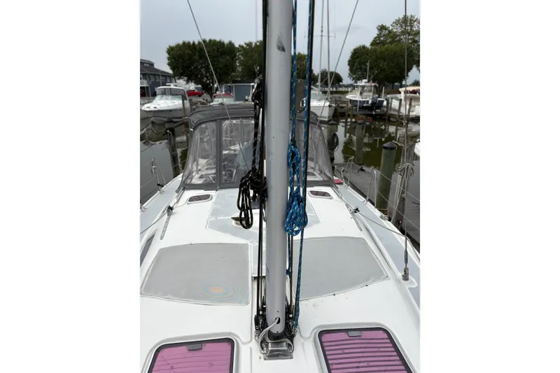 Slide: The Image of 2002 Hunter 386 sailboat docked, featuring deck and mast details. - 5