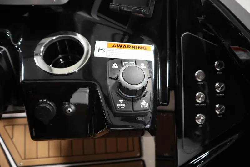 Slide: The Image of Control panel of 2026 Yamaha Boats 252SD with cup holder and warning label. - 22