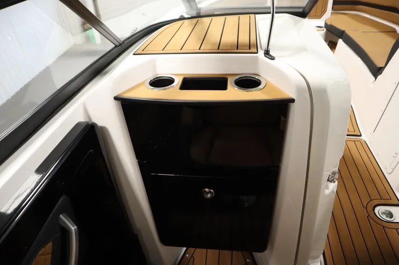 Slide: The Image of 2026 Yamaha Boats 252SD interior with sleek wood accents and cup holders. - 30