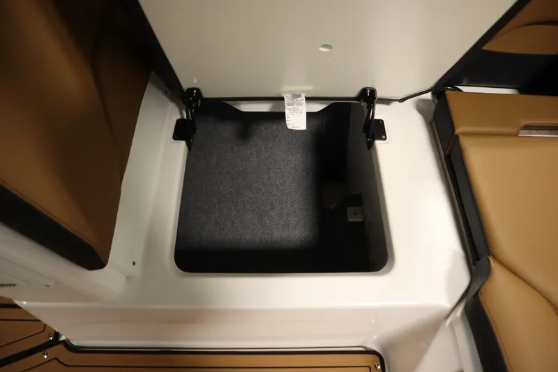 Slide: The Image of Storage compartment in 2026 Yamaha Boats 252SD, featuring sleek design and brown seating. - 35