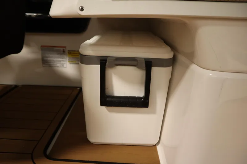 Slide: The Image of 2026 Yamaha Boats 252SD interior with a compact white cooler. - 37