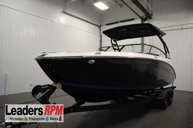 Slide: The Image of 2026 Yamaha Boats 252SD in showroom, black hull, on trailer. - 55