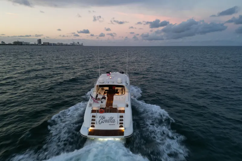 Slide: The Image of Luxury 1999 Mangusta 80 yacht cruising at sunset on open sea. - 12