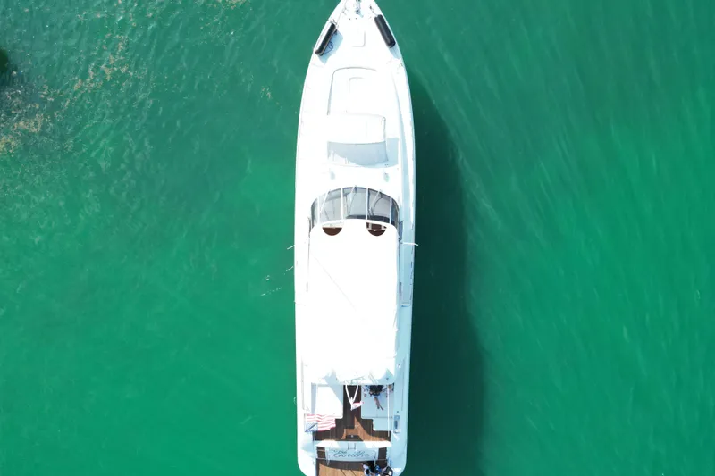 Slide: The Image of Aerial view of 1999 Mangusta 80 yacht on turquoise water. - 14