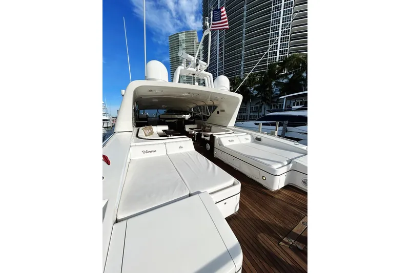 Slide: The Image of 1999 Mangusta 80 yacht docked in a marina with other boats. - 18