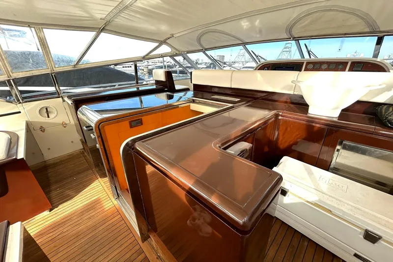 Slide: The Image of Luxurious 1999 Mangusta 80 yacht docked, featuring spacious deck and elegant design. - 23