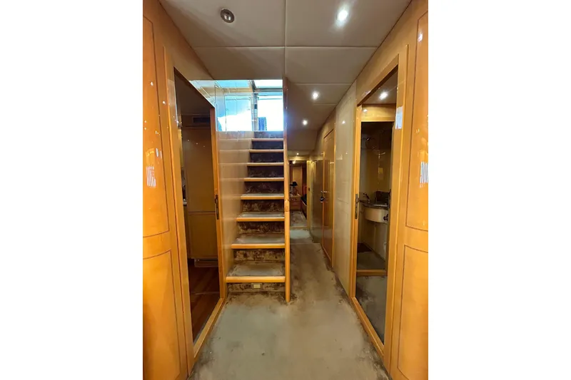 Slide: The Image of Luxurious 1999 Mangusta 80 yacht interior with elegant seating and wooden flooring. - 28