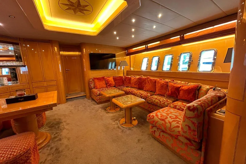 Slide: The Image of Luxurious 1999 Mangusta 80 yacht interior with elegant seating and wooden flooring. - 30