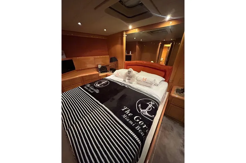 Slide: The Image of Luxurious 1999 Mangusta 80 yacht interior with white sofa, wooden accents, and large windows. - 34