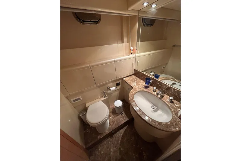 Slide: The Image of Luxurious interior of a 1999 Mangusta 80 yacht with elegant wood finishes and plush seating. - 35