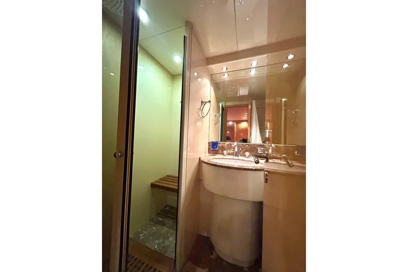 Slide: The Image of Interior view of 1999 Mangusta 80 yacht, featuring a luxurious hallway and staircase. - 38