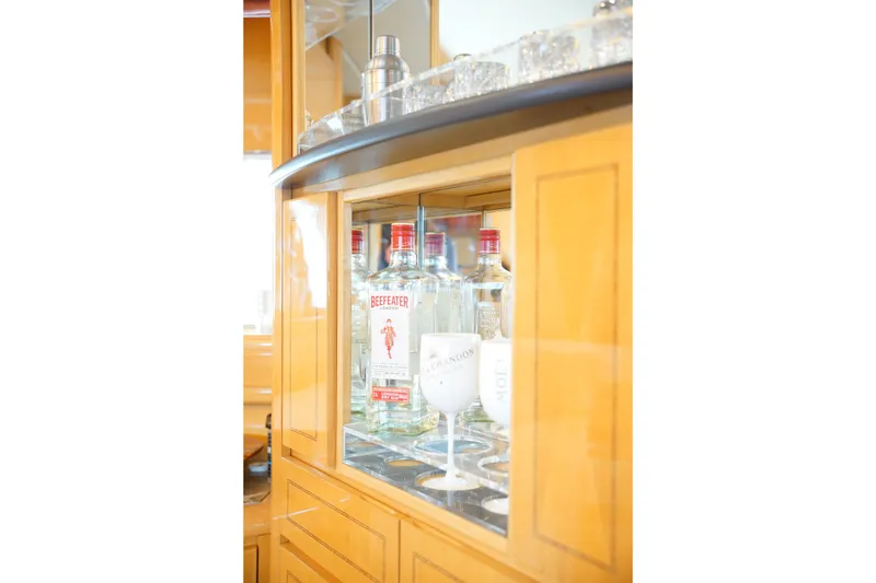 Slide: The Image of Bar cabinet with Beefeater gin bottles and glasses on a 1999 Mangusta 80 yacht. - 39