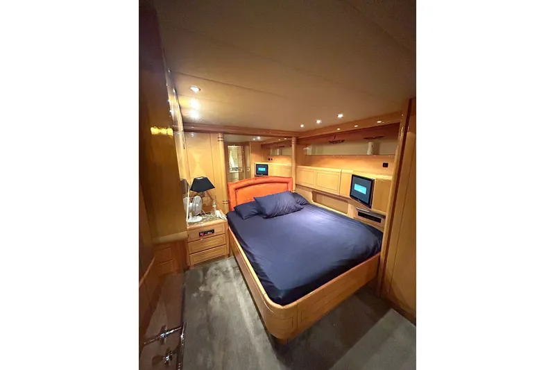 Slide: The Image of Luxurious 1999 Mangusta 80 yacht bedroom with wood paneling and modern amenities. - 43