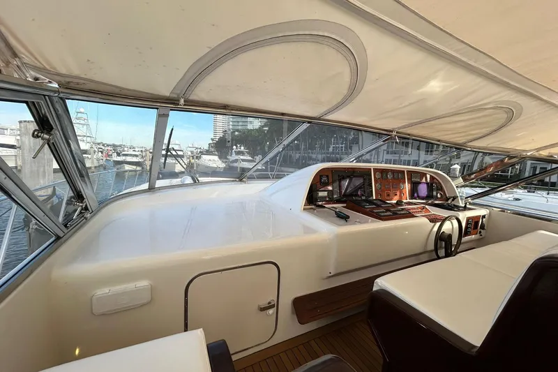 Slide: The Image of Interior view of 1999 Mangusta 80 yacht cockpit with navigation controls and seating. - 49