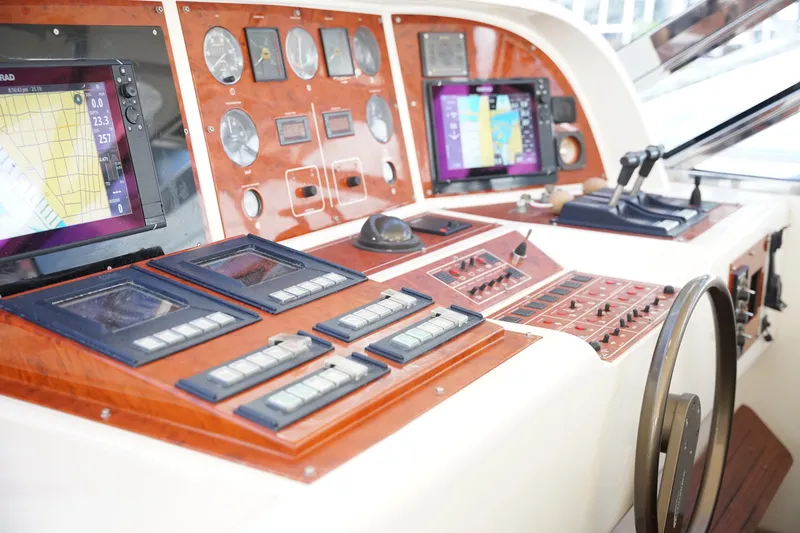 Slide: The Image of Control panel of a 1999 Mangusta 80 yacht with navigation screens and gauges. - 50