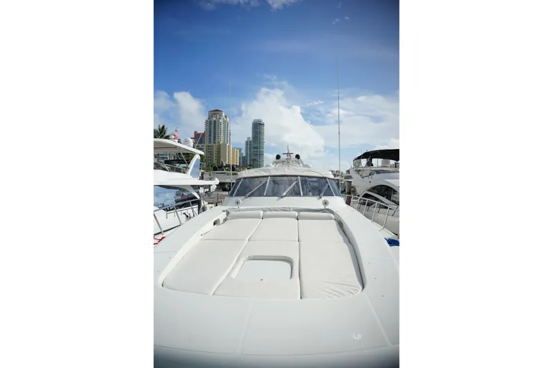 Slide: The Image of 1999 Mangusta 80 yacht docked with city skyline in background. - 53