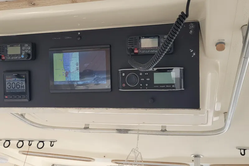 Slide: The Image of Control panel of a 1992 Luhrs 380 Open boat with navigation and communication equipment. - 11