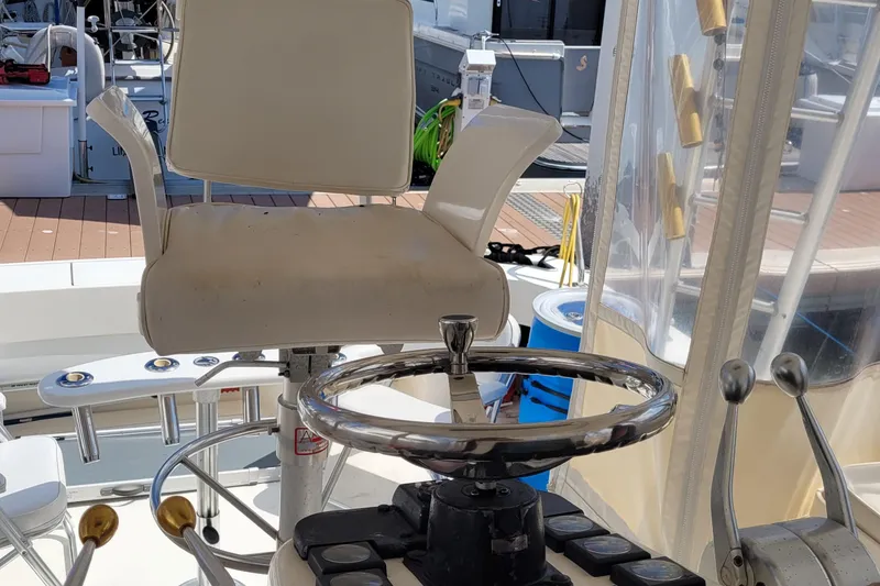 Slide: The Image of 1992 Luhrs 380 Open boat helm with steering wheel and captain's chair. - 13