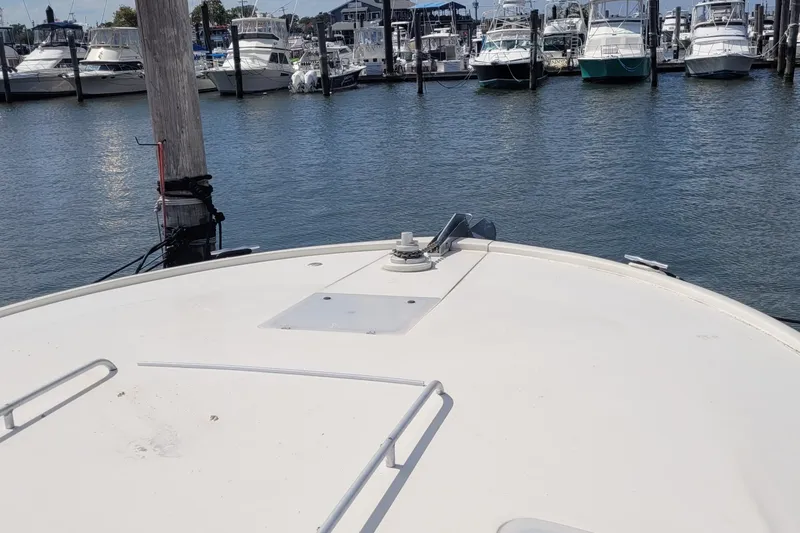 Slide: The Image of Bow view of 1992 Luhrs 380 Open yacht docked in marina. - 16