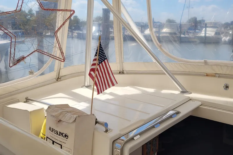Slide: The Image of 1992 Luhrs 380 Open boat interior with American flag and lifesaving equipment. - 21