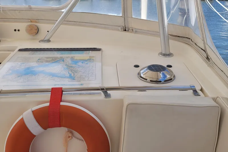 Slide: The Image of 1992 Luhrs 380 Open boat cockpit with map, compass, and life preserver. - 22