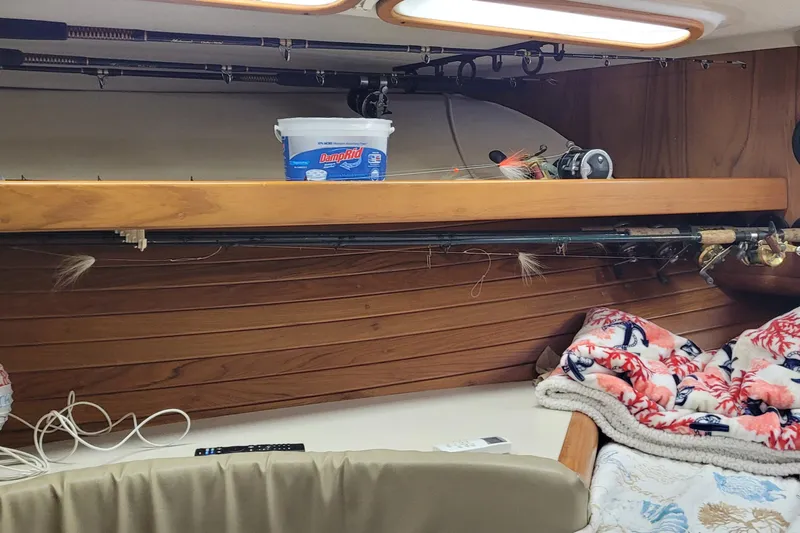 Slide: The Image of Interior of 1992 Luhrs 380 Open boat with fishing rods and cozy bedding. - 24