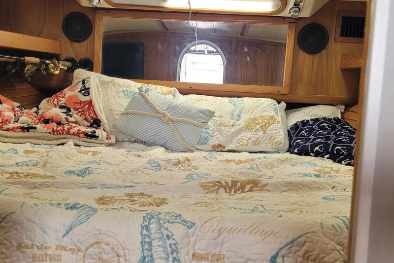 Slide: The Image of Cozy cabin interior of 1992 Luhrs 380 Open with nautical-themed bedding. - 25