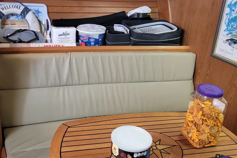 Slide: The Image of Interior of a 1992 Luhrs 380 Open boat with snacks and supplies on a wooden table. - 30