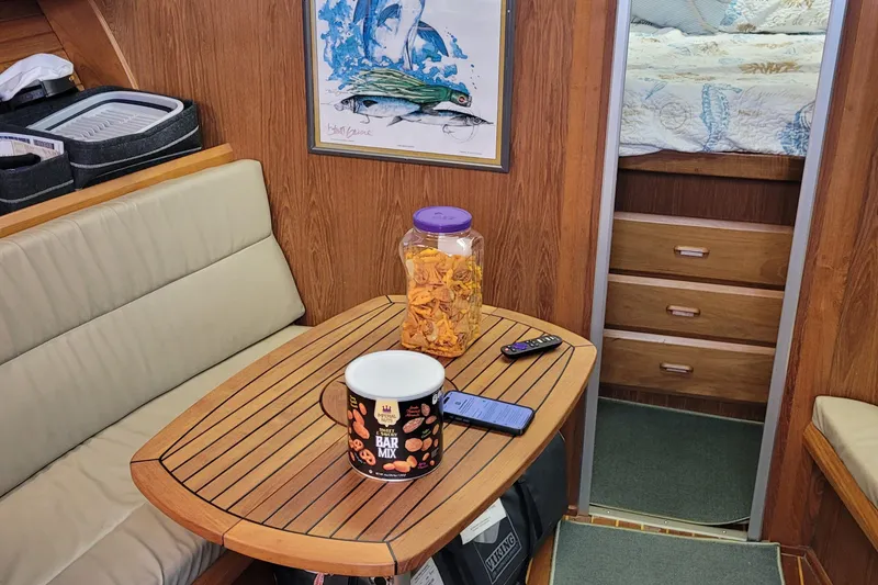 Slide: The Image of Interior of a 1992 Luhrs 380 Open boat with snacks on a wooden table. - 31