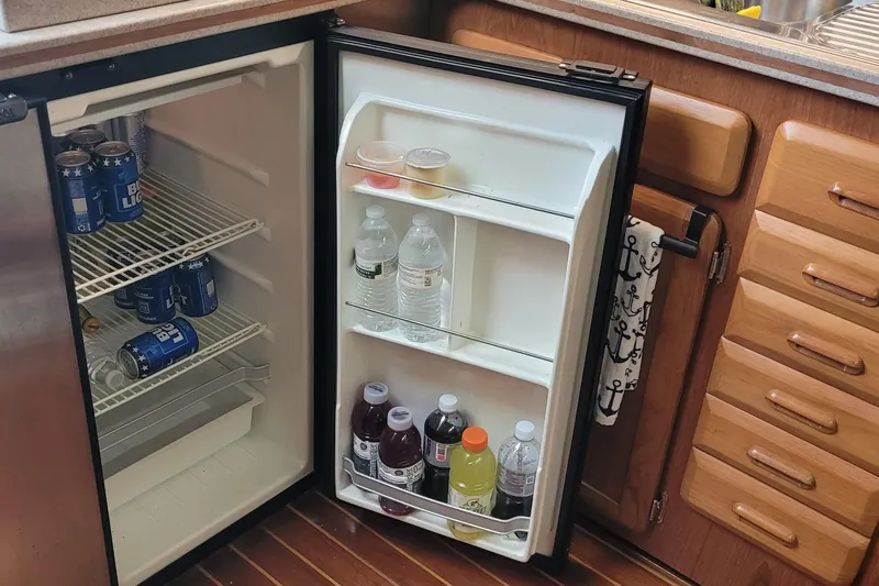 Slide: The Image of Mini fridge stocked with drinks on a 1992 Luhrs 380 Open boat. - 37