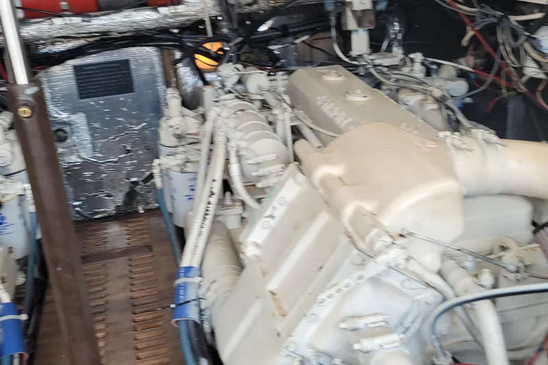 Slide: The Image of Engine room of a 1992 Luhrs 380 Open boat, showcasing mechanical components and wiring. - 41