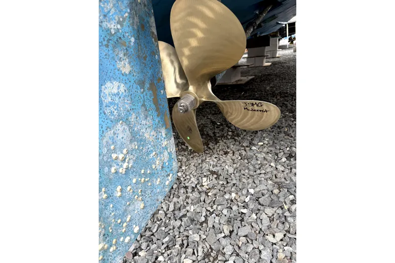 Slide: The Image of Propeller of 1992 Luhrs 380 Open boat on gravel, showing barnacle growth. - 43