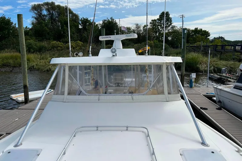 Slide: The Image of 1992 Luhrs 380 Open boat docked, featuring a Garmin radar system and enclosed cockpit. - 44