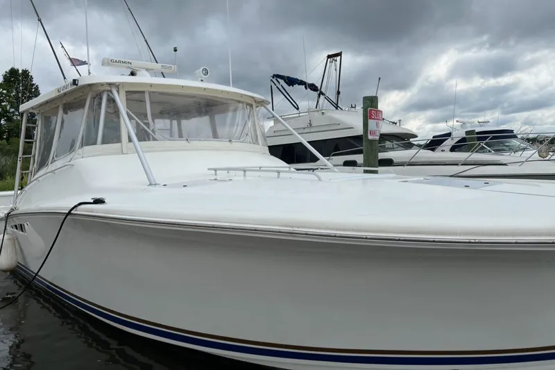 Slide: The Image of 1992 Luhrs 380 Open boat docked at marina under cloudy skies. - 45