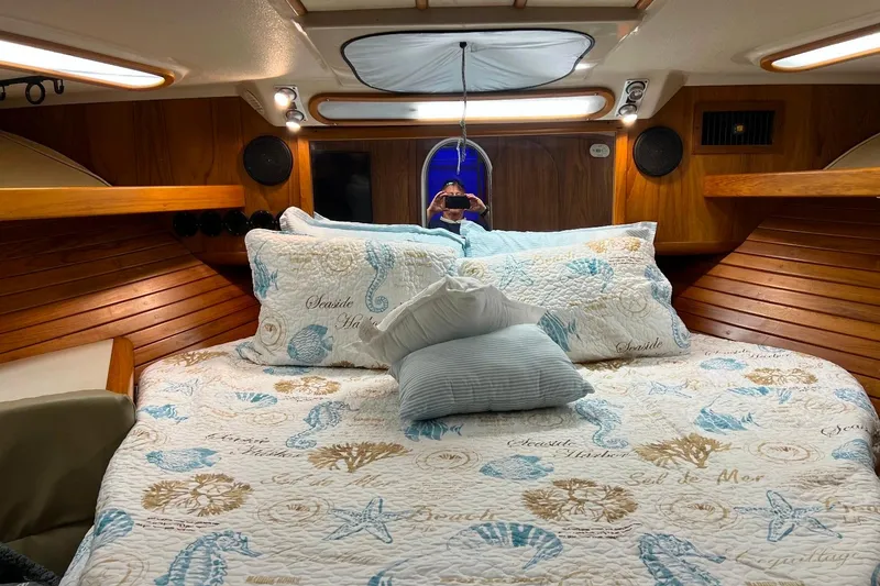 Slide: The Image of Cozy cabin interior of 1992 Luhrs 380 Open with nautical-themed bedding. - 46