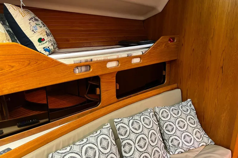 Slide: The Image of Cozy cabin interior of 1992 Luhrs 380 Open with wooden bunk and patterned pillows. - 48