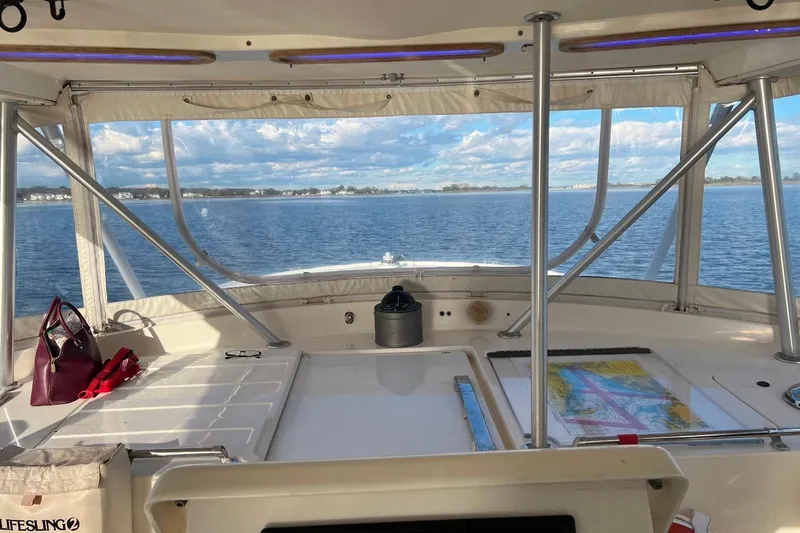 Slide: The Image of Interior view of 1992 Luhrs 380 Open boat with ocean backdrop and navigation map. - 52