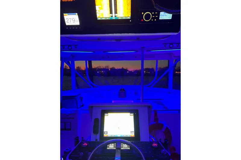 Slide: The Image of Interior view of 1992 Luhrs 380 Open boat cockpit with illuminated navigation screens. - 54