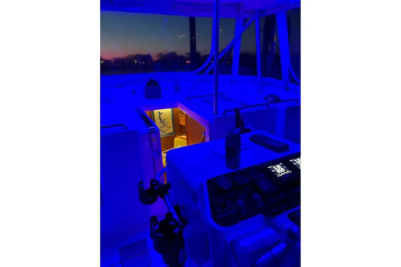 Slide: The Image of 1992 Luhrs 380 Open boat interior with blue lighting at dusk. - 55
