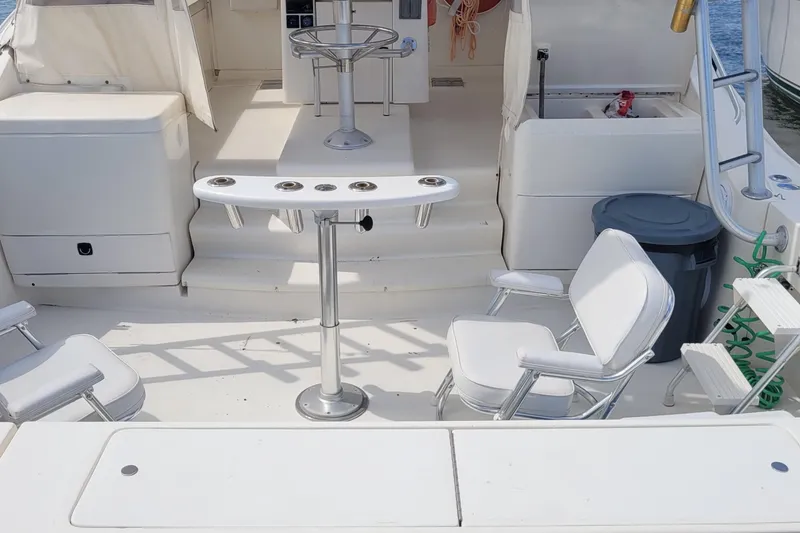 Slide: The Image of 1992 Luhrs 380 Open boat interior with seating and fishing rod holders. - 6