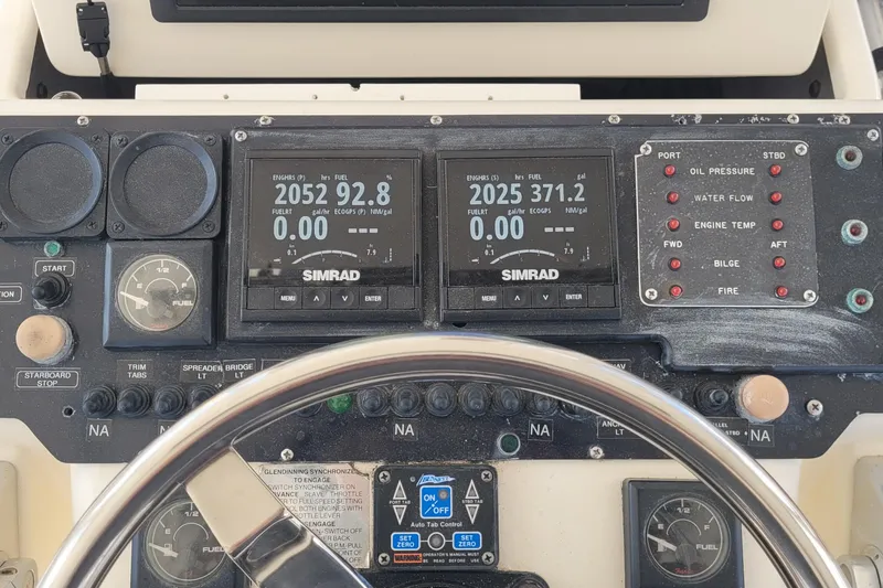Slide: The Image of 1992 Luhrs 380 Open boat dashboard with Simrad displays and control panel. - 7