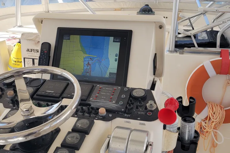 Slide: The Image of Helm of 1992 Luhrs 380 Open boat with navigation equipment and safety gear. - 9
