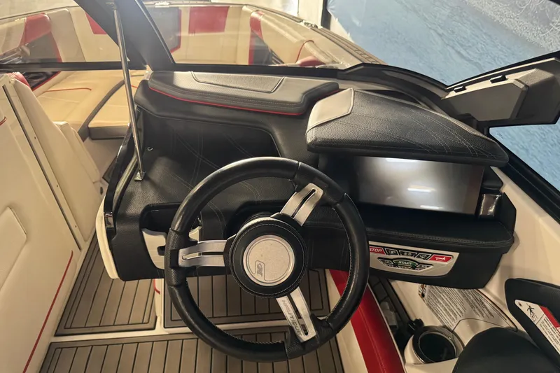 Slide: The Image of 2019 Nautique Super Air Nautique G23 cockpit with steering wheel and dashboard controls. - 10