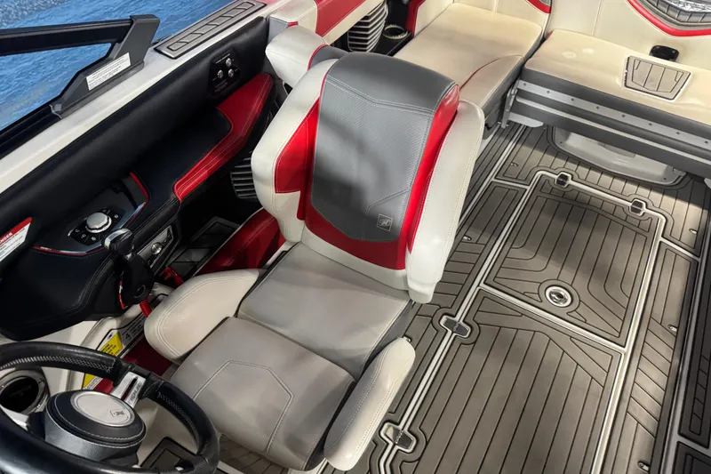 Slide: The Image of 2019 Nautique Super Air Nautique G23 interior with red and gray seating, detailed flooring. - 11