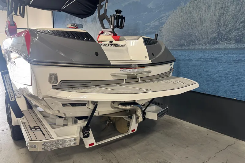 Slide: The Image of 2019 Nautique Super Air Nautique G23 boat rear view in showroom setting. - 4